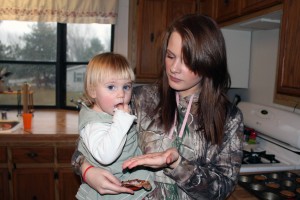 April feeds Avah a muffin